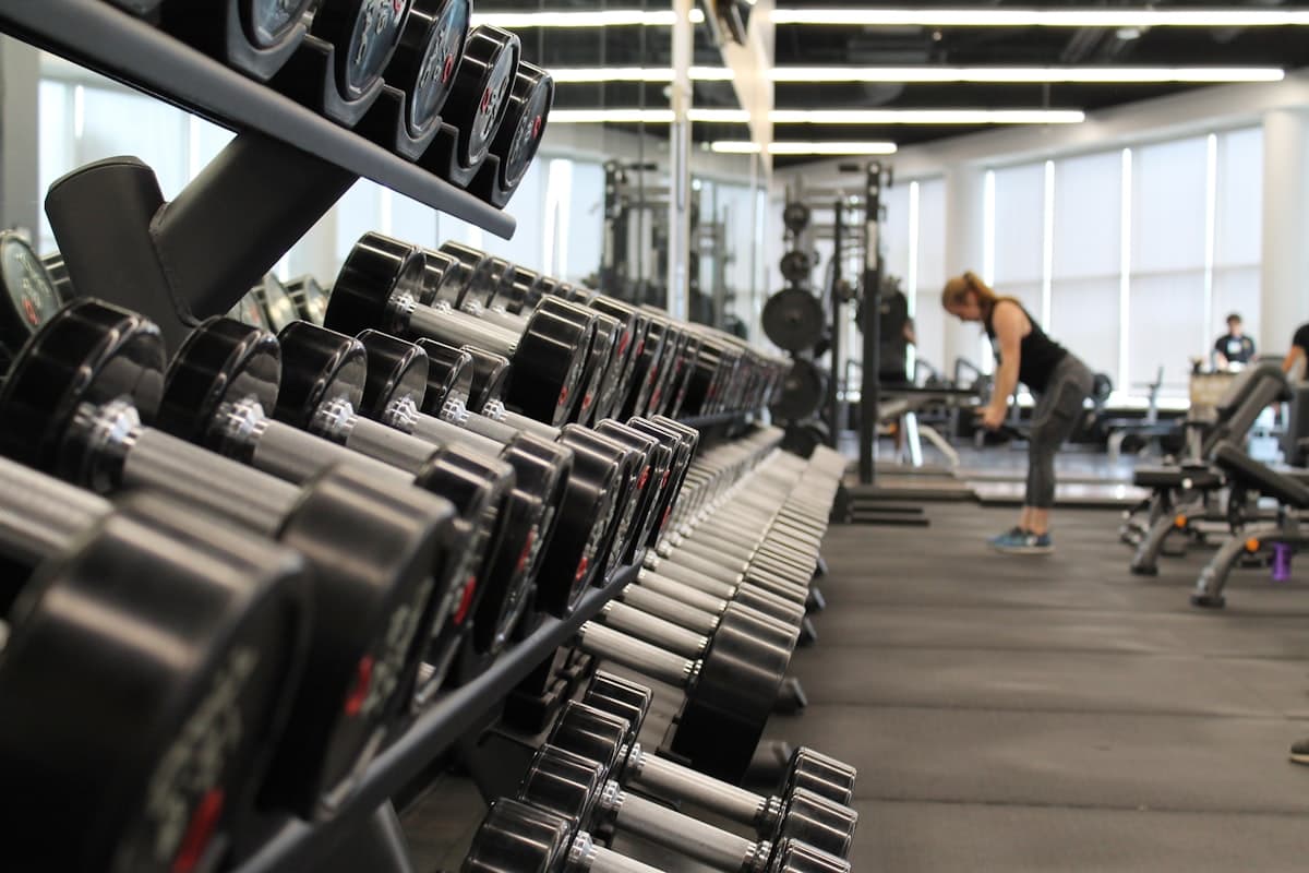 Loaded barbell in a dark gym